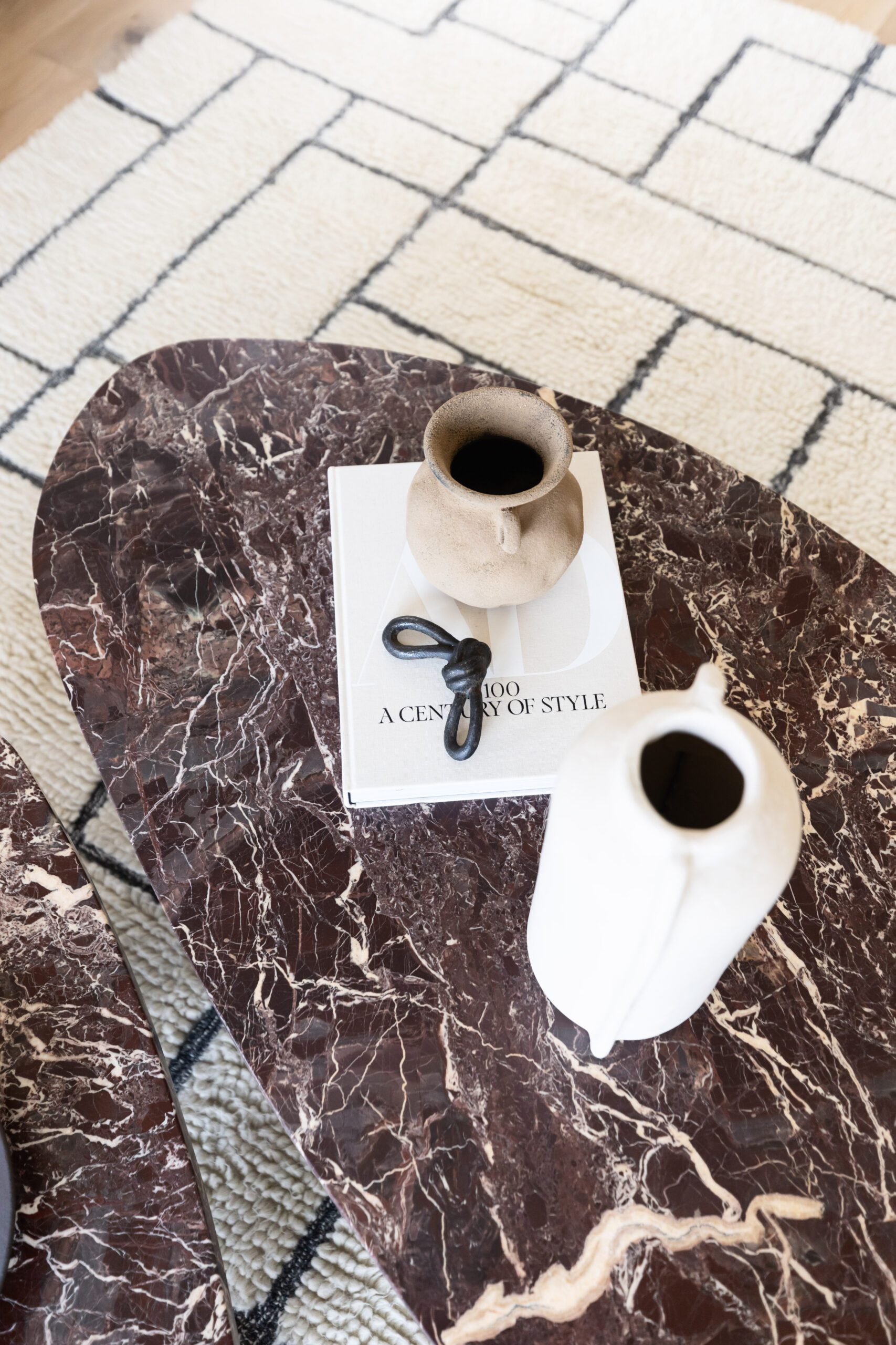 Marble coffee table with modern white ceramics and book