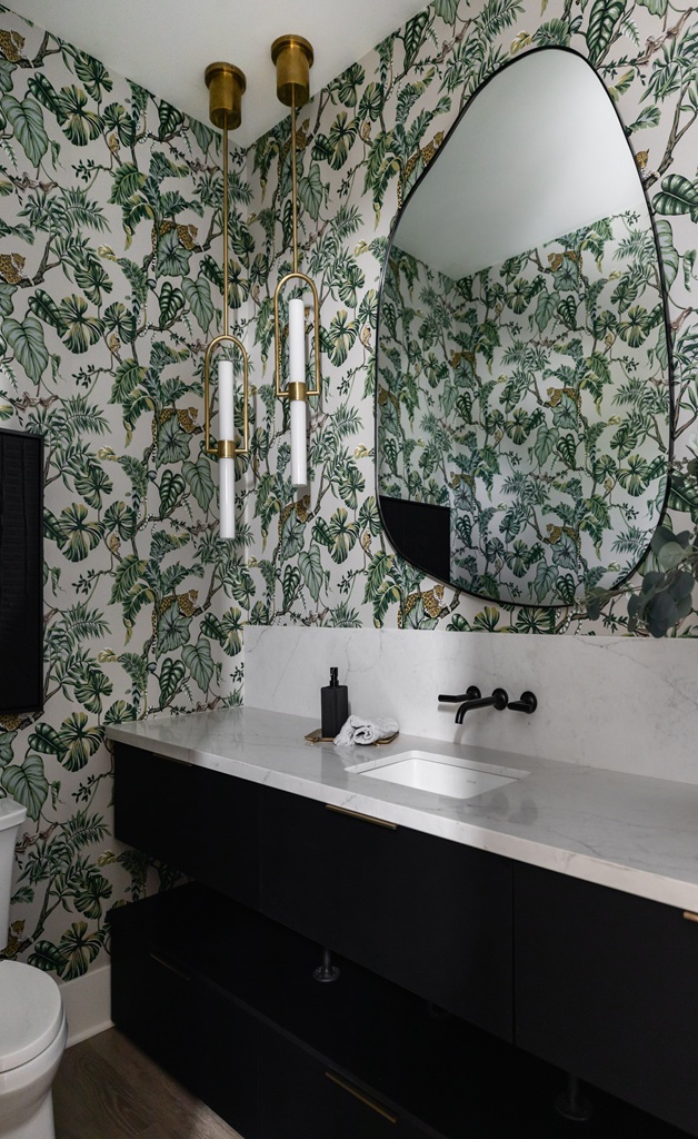 Bathroom with tropical wallpaper and black vanity