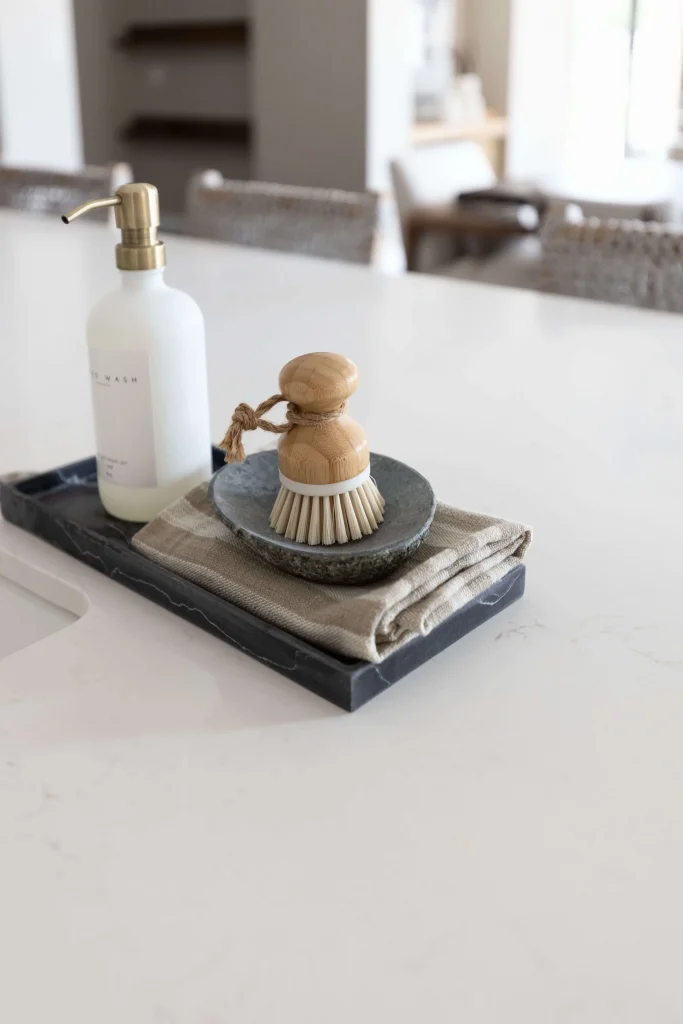 Soap dispenser and scrub brush on kitchen counter