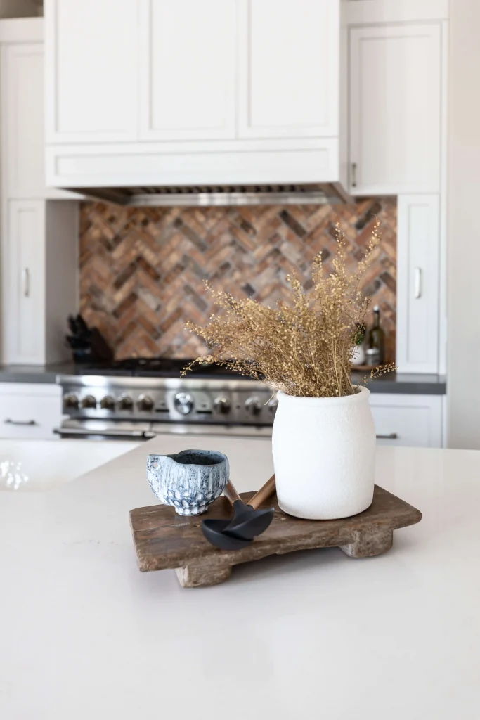 Vase with dried florals and bowl on rustic wooden riser