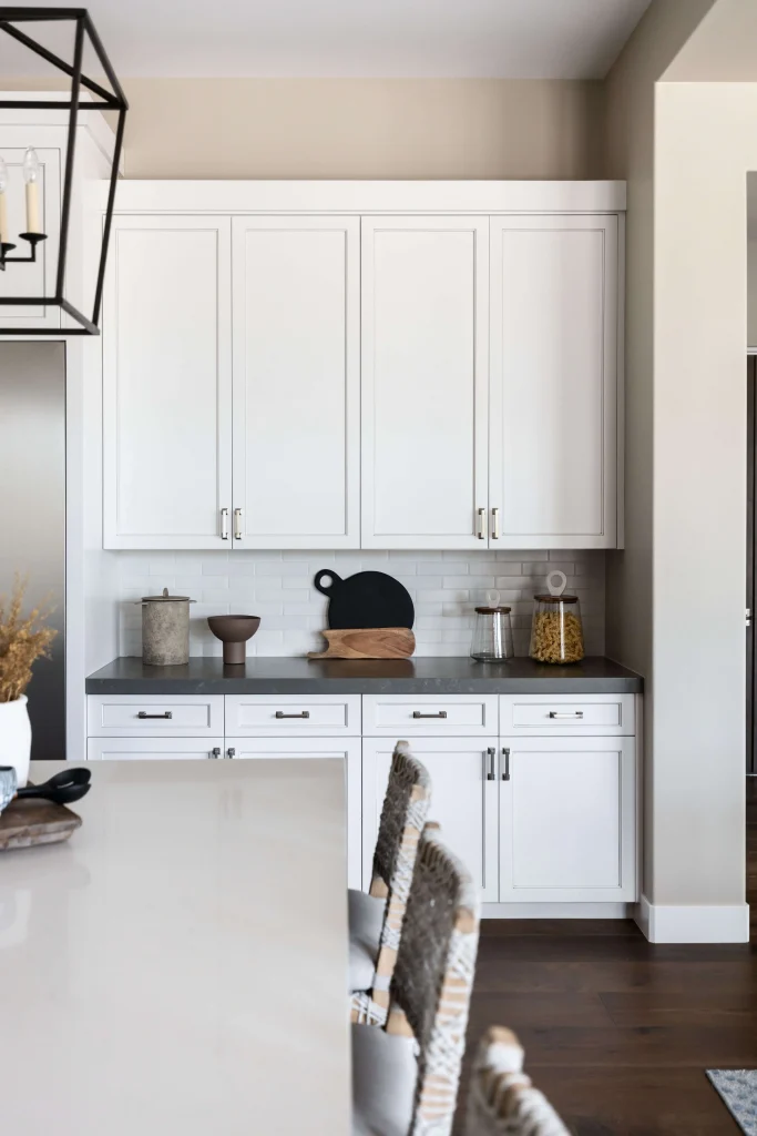 White kitchen cabinets with black and wood cutting boards