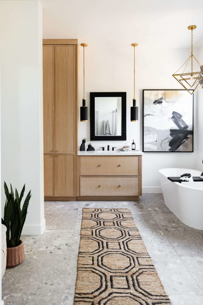 Bathroom with wood vanity and black pendant lights