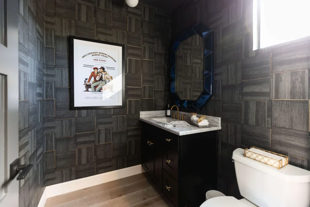 Powder room with dark textured wallpaper and modern sink