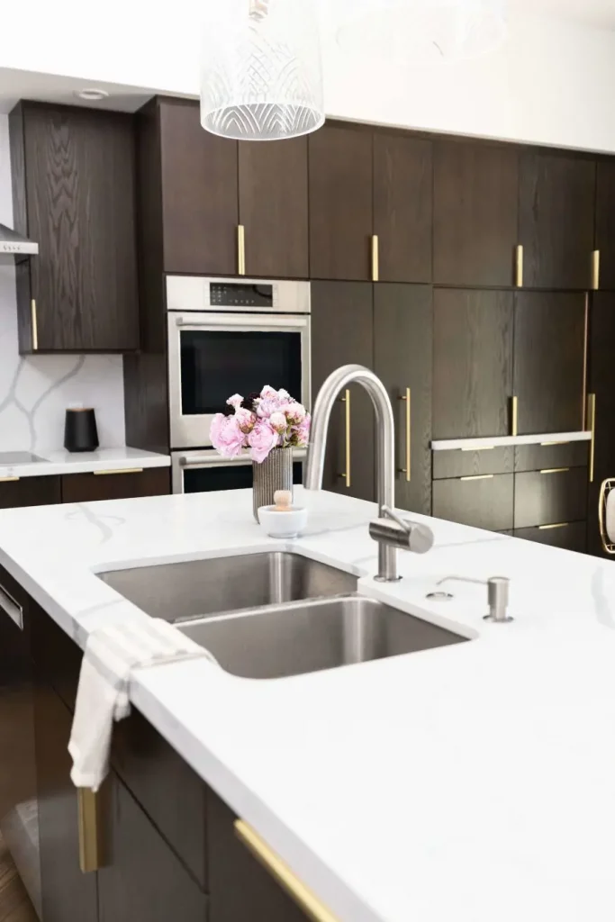 Modern kitchen dining area with gold-accented chairs and table.