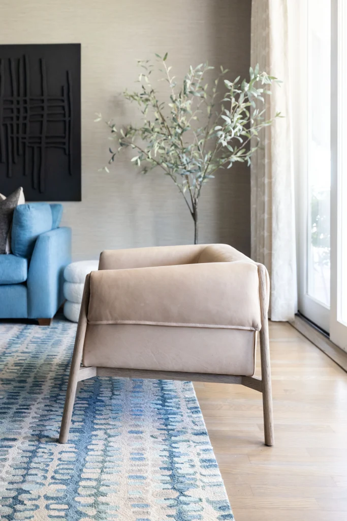 Beige armchair on blue patterned rug