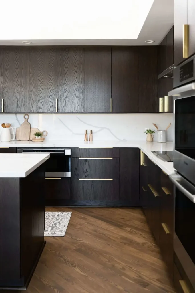 Dark wood kitchen cabinets with white marble backsplash