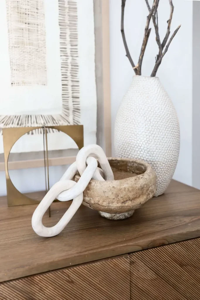 Decorative ceramic chain in stone bowl with textured vase