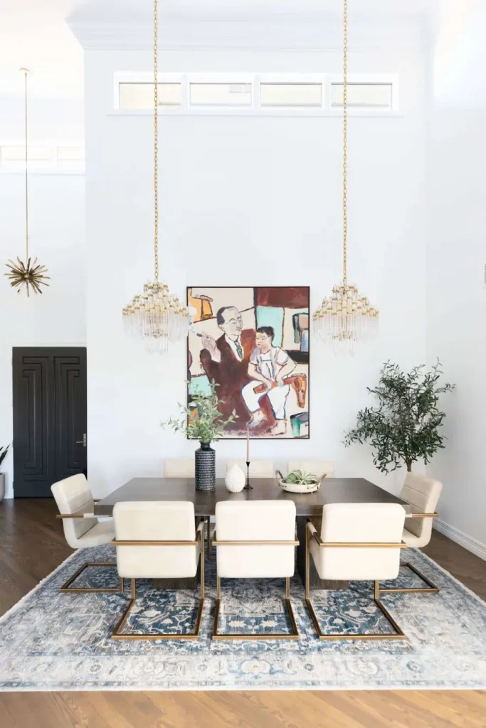 Contemporary dining room with chandelier lighting and modern artwork