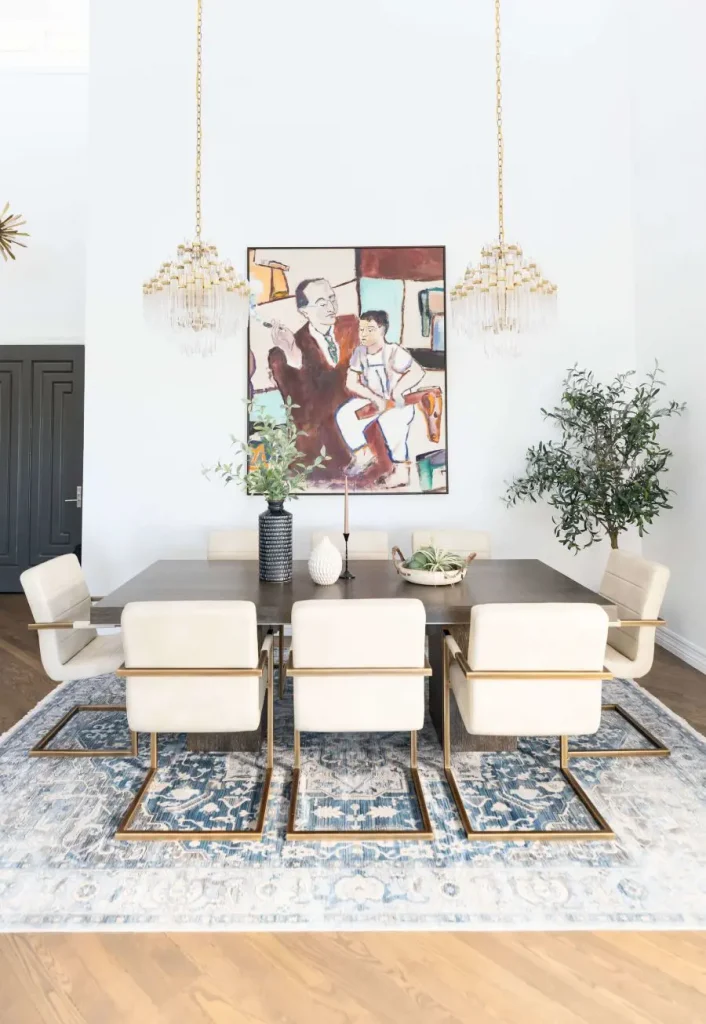 Modern dining room with white chairs, dark table, and abstract artwork