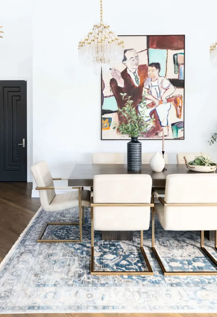 Elegant dining room with modern chairs and vibrant artwork.