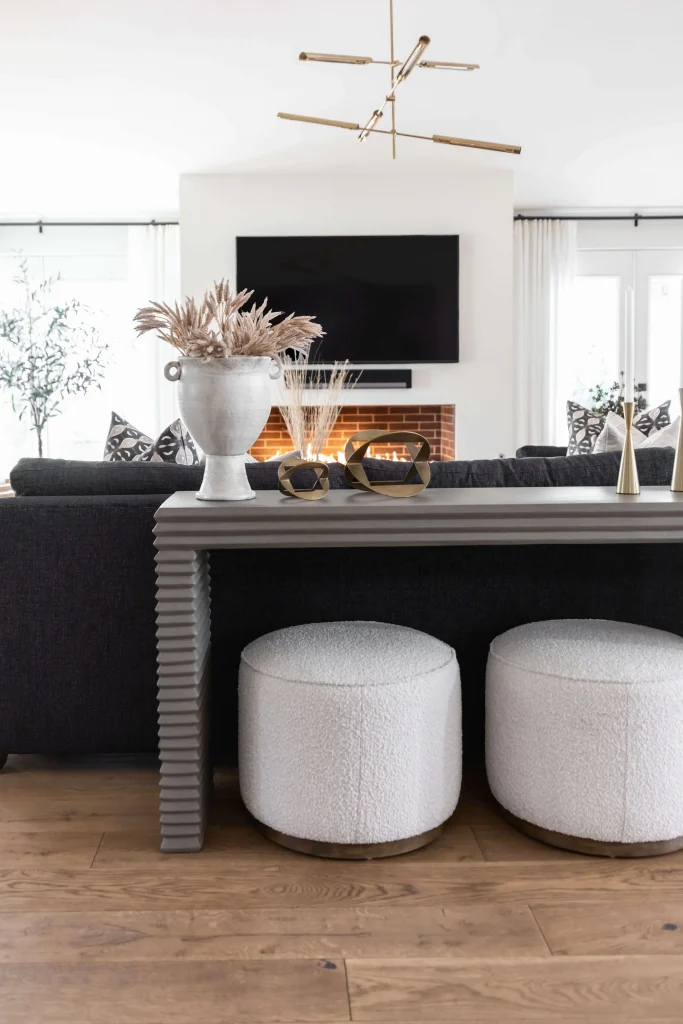 Close-up of console with white ottomans under it