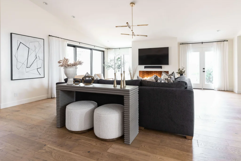 Full living room view with sofa, TV, and modern lighting