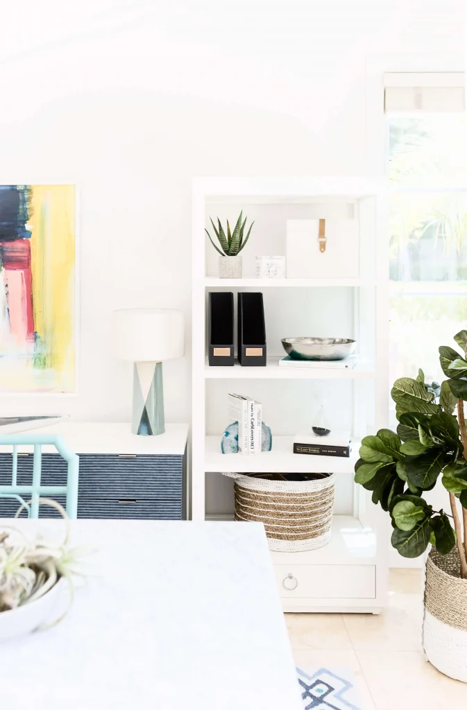 Bright and modern home office corner with white shelf and decor