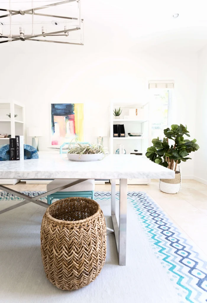 Bright and airy home office with marble desk and vibrant decor