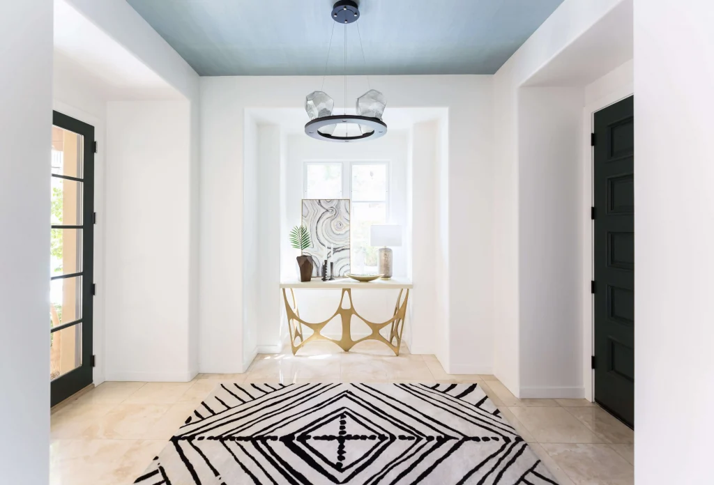 Entryway with geometric rug and decorative console table