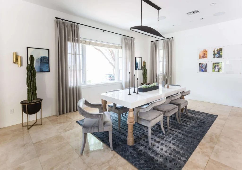 Dining room with white table and gray velvet chairs