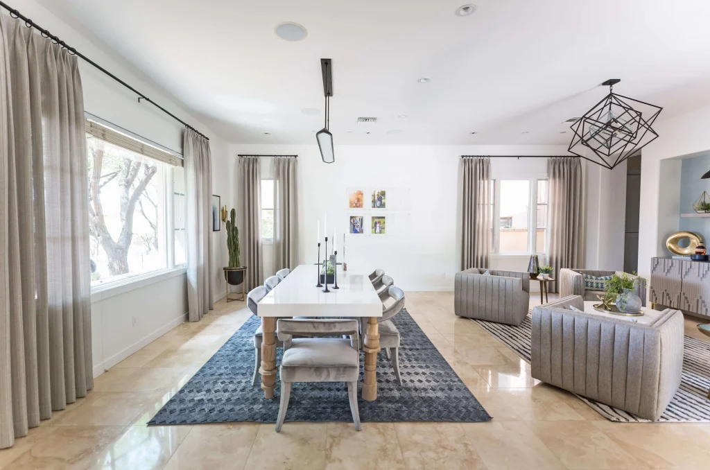 Bright dining room with long white table and adjacent seating area
