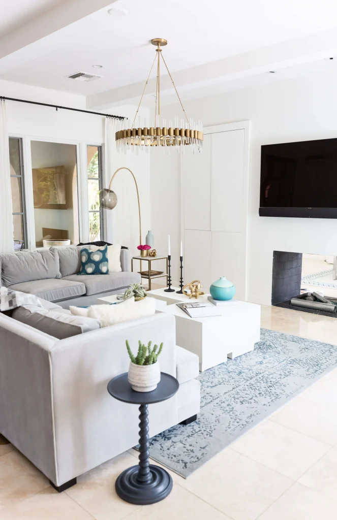 Black twisted pedestal side table with white textured pot holding a green succulent.