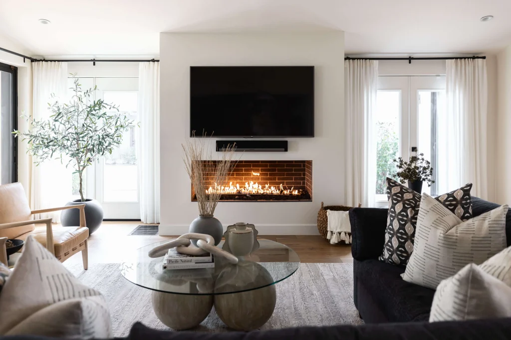 Fireplace living room with glass table and neutral decor