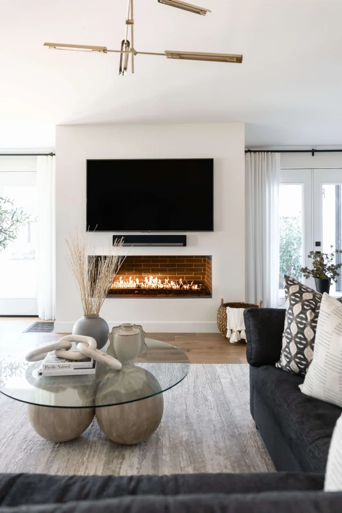 Fireplace wall with round-base glass coffee table