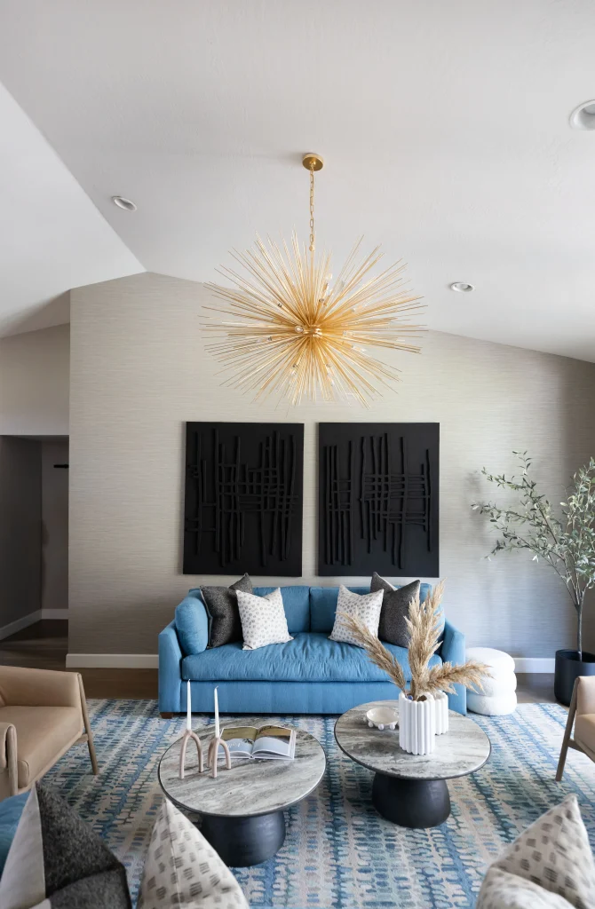Living room with blue sofa and gold chandelier