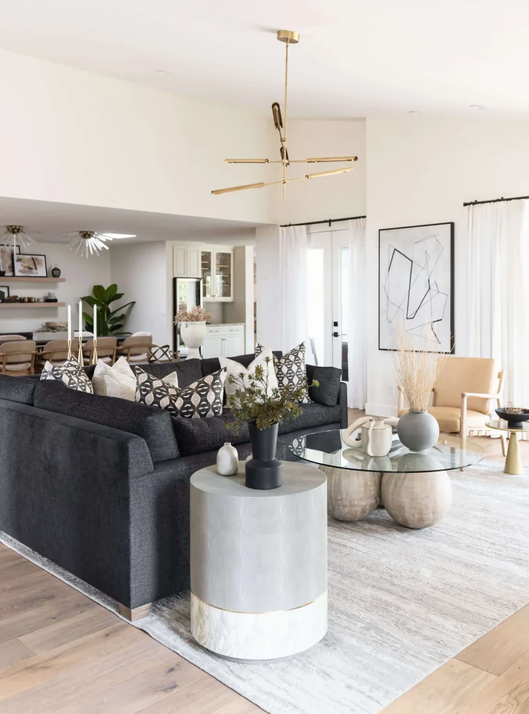 Full seating view with light wood accents and sofa