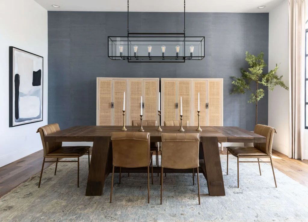 Modern dining room with leather chairs and blue accent wall