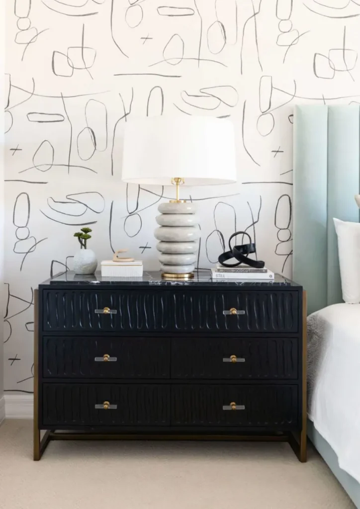 Bedroom nightstand with unique lamp and decorative books