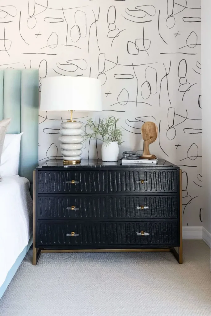 Black textured nightstand with marble lamp and decorative vase