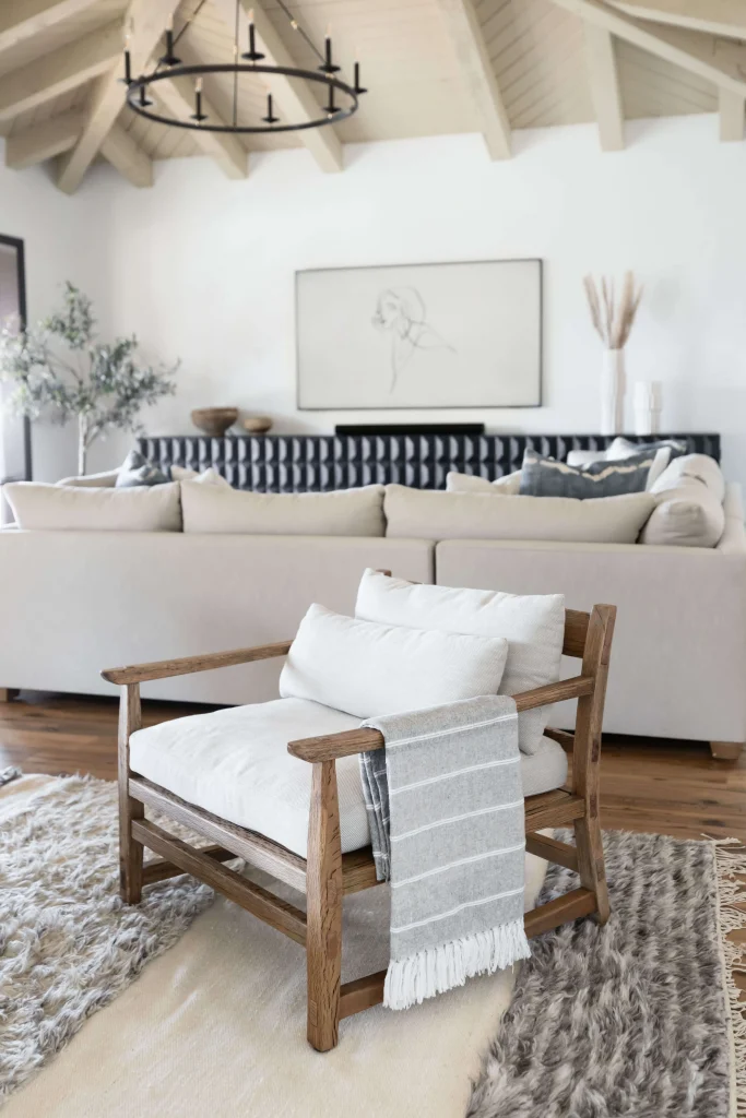 Wooden armchair with cushions and striped throw blanket