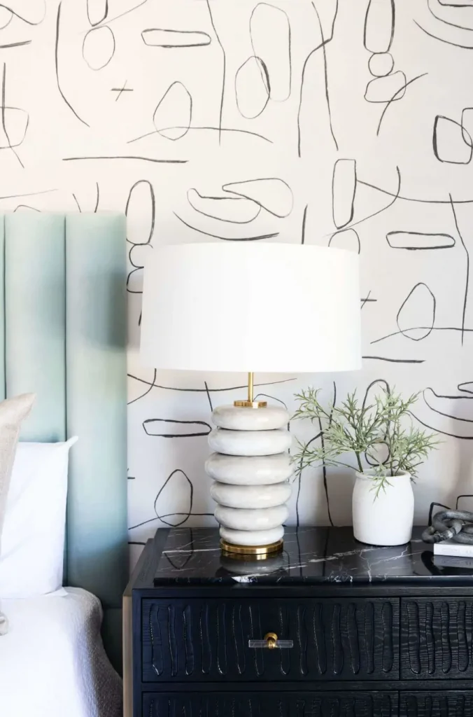 Bedside table with white lamp and decorative vase