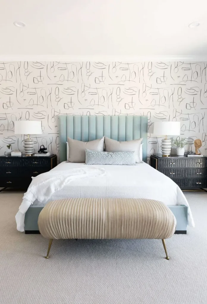 Elegant bedroom setup with pastel blue upholstered bed and beige seating