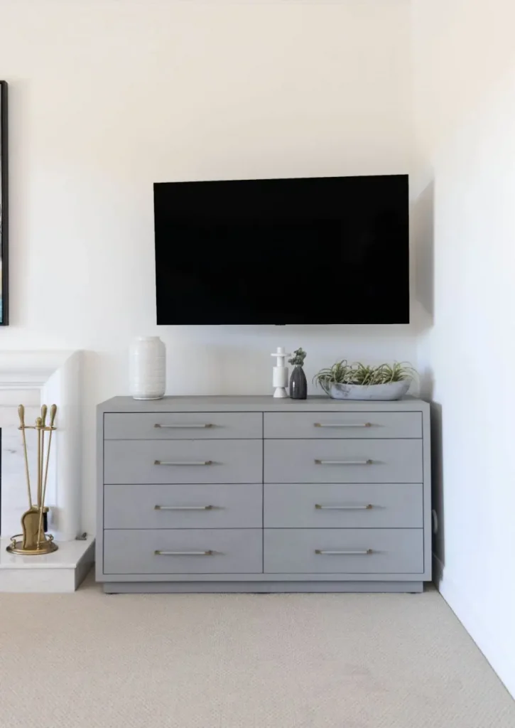 Minimalist living room with gray dresser and wall-mounted TV