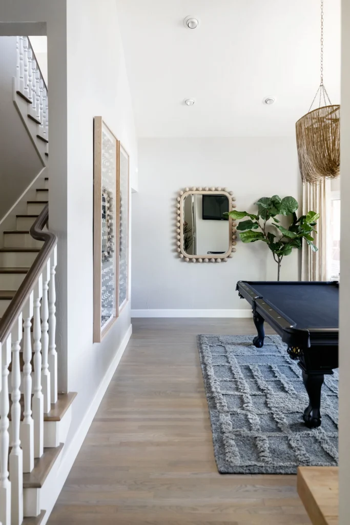 Game room with black pool table and mirror