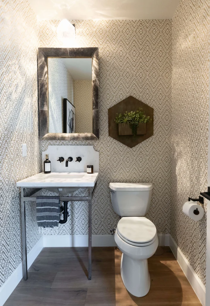 Modern powder bathroom with wallpaper and pedestal sink