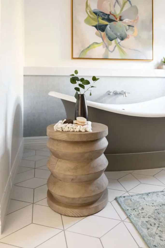 Minimalist bathroom with wooden stool and decorative vase