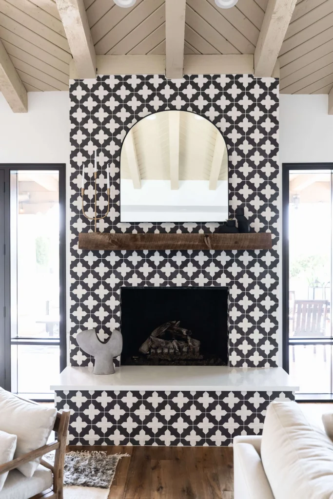 Fireplace with black-and-white patterned tile and wooden mantel