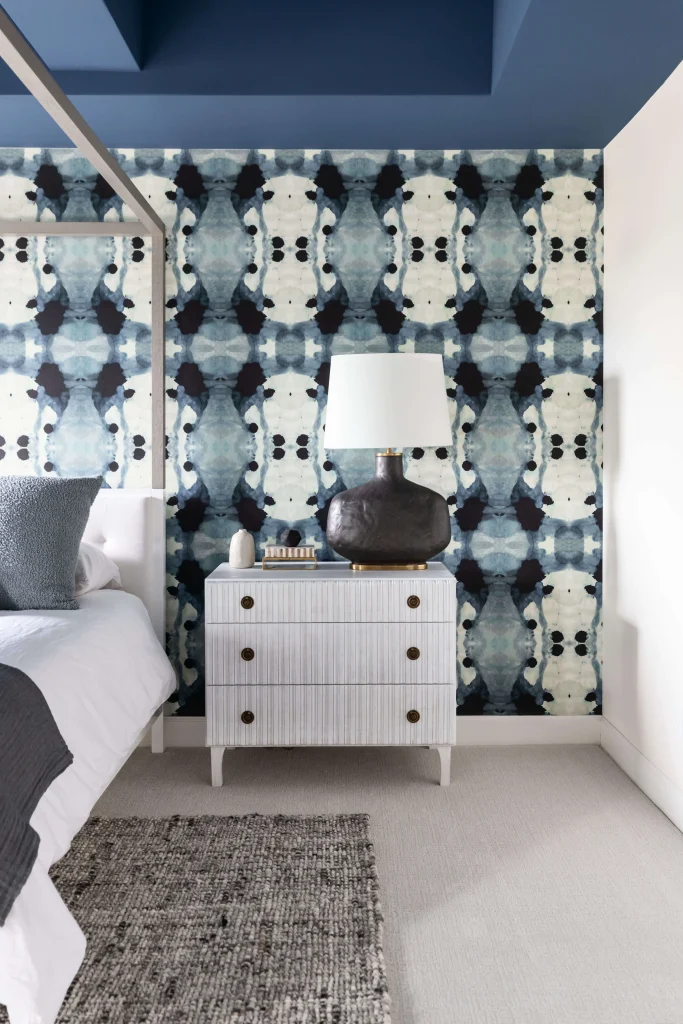 Bedroom corner with modern white nightstand and wallpaper