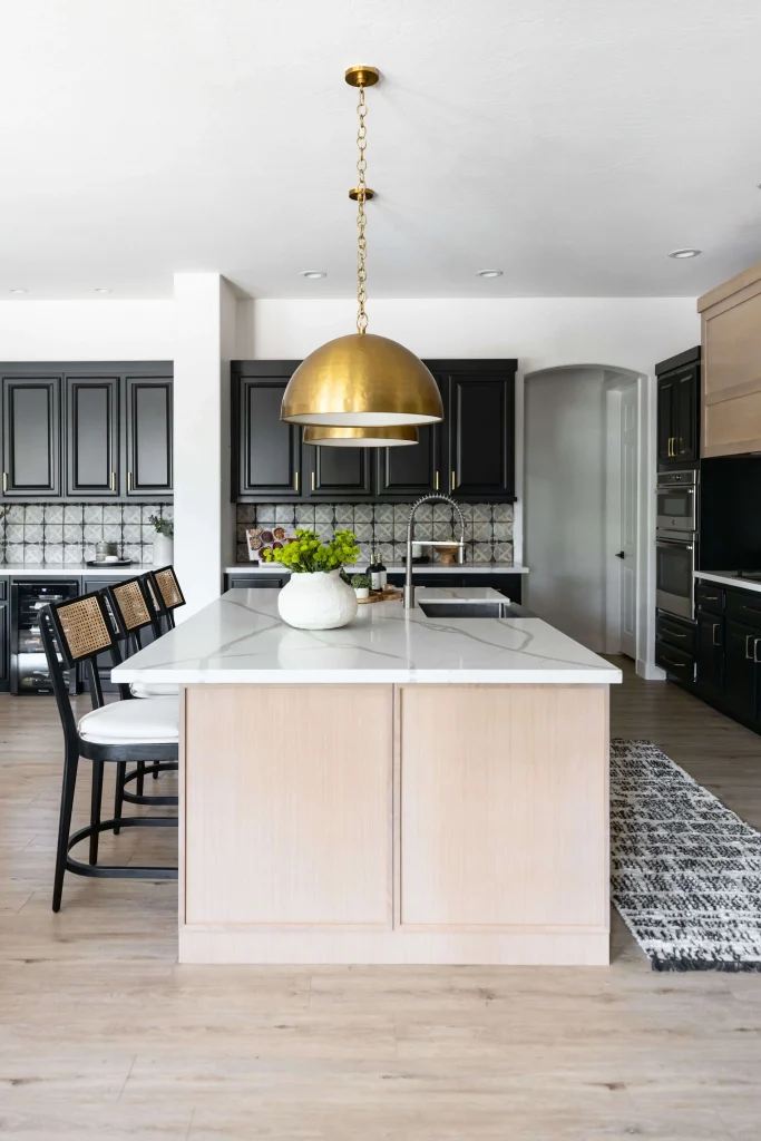 Luxury kitchen with black cabinets and marble island