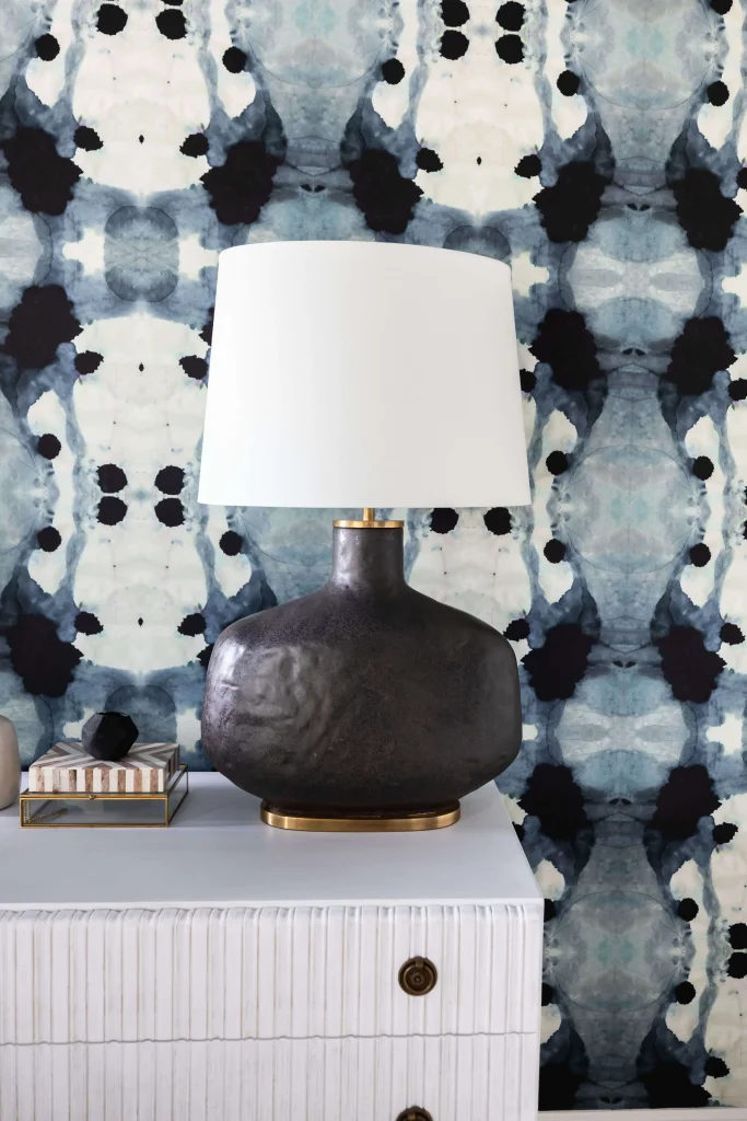 Nightstand with lamp and artistic wallpaper