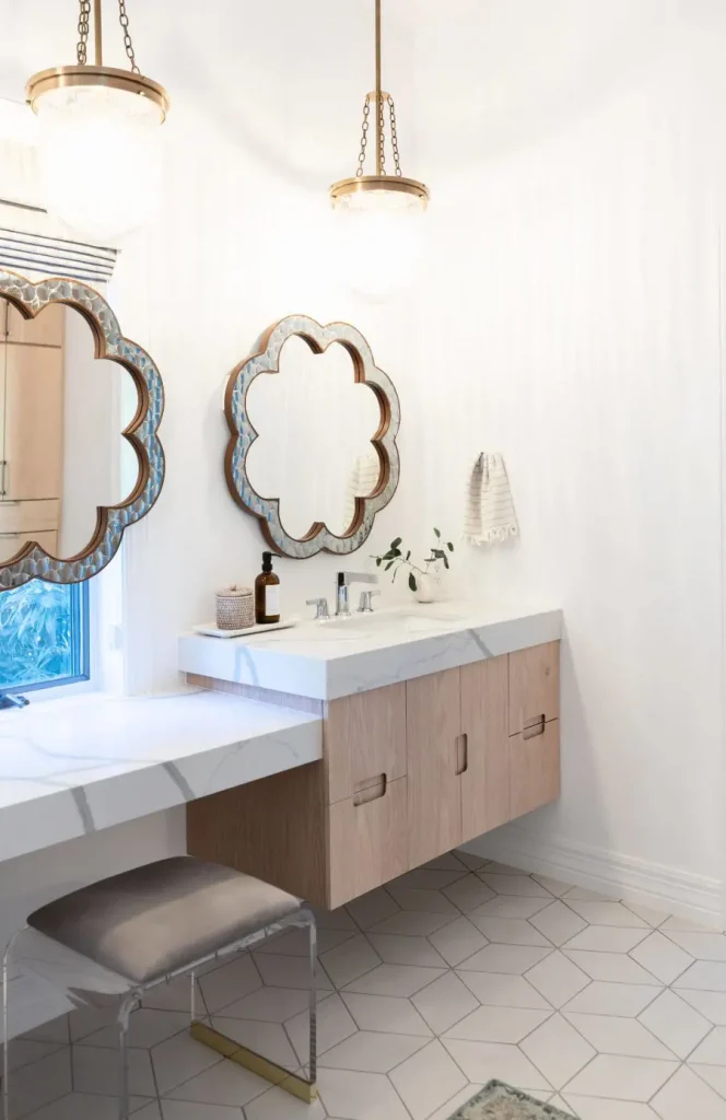 Modern bathroom vanity with floral mirrors and acrylic stool