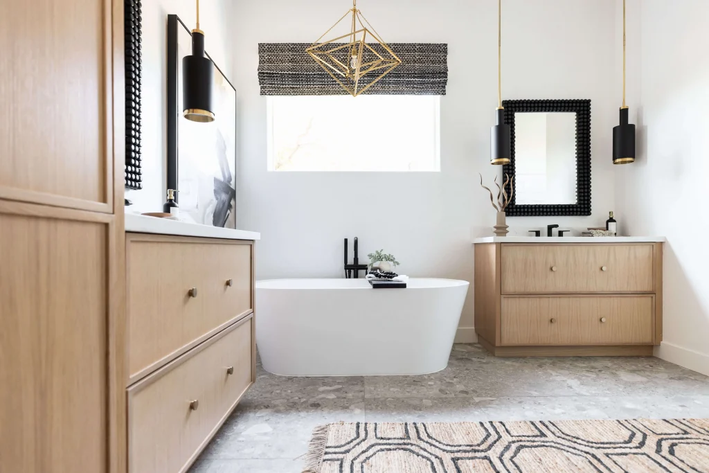 Bright bathroom with freestanding tub and wood vanities