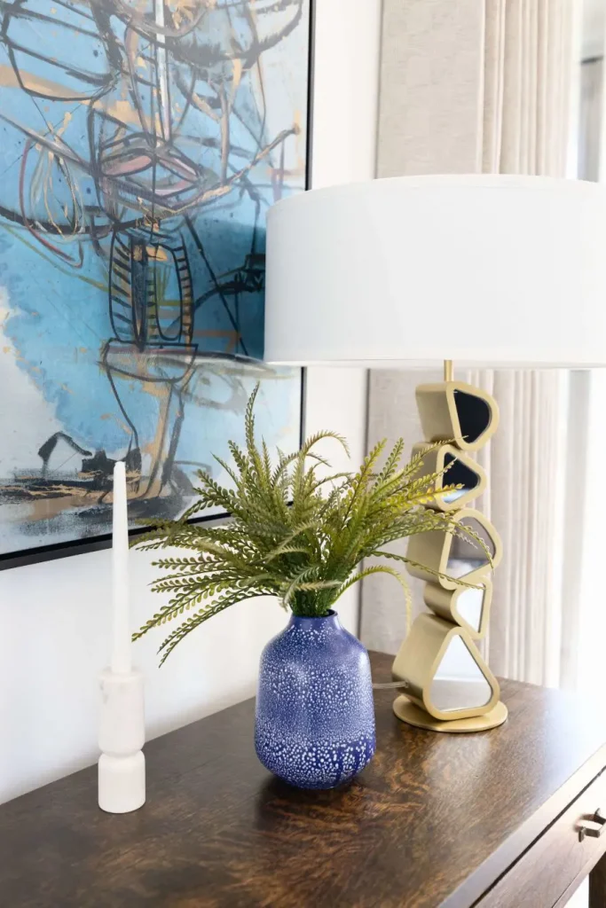 Modern table decor with abstract art and lamp