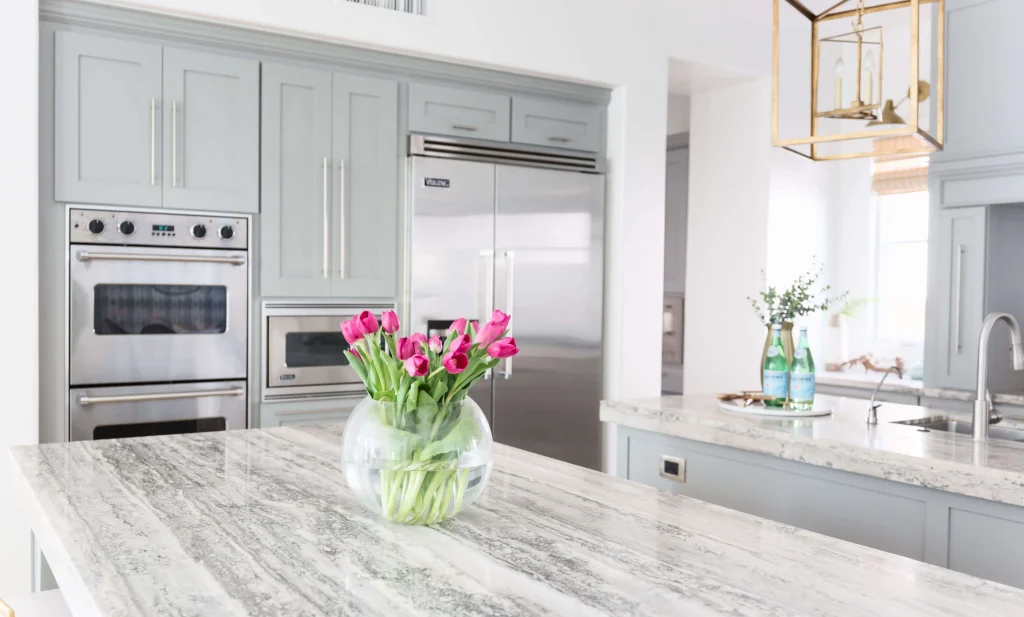 Luxury kitchen with gray cabinets and pink tulips