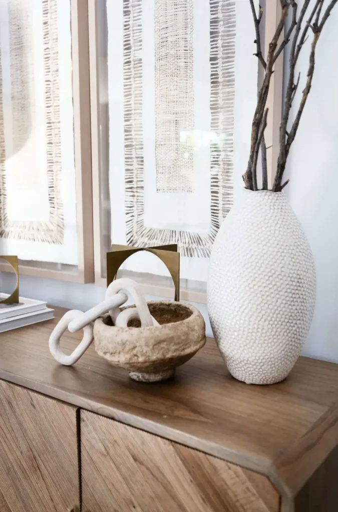 Close-up of natural decor on wood cabinet with modern art