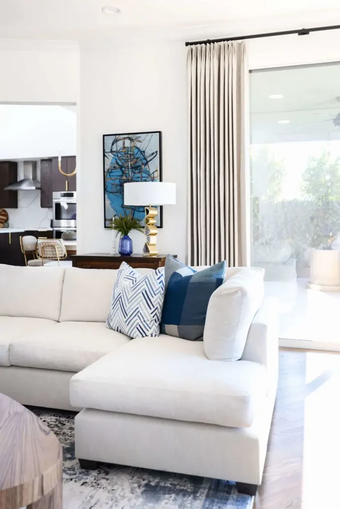 Bright living room with cream sofa and blue decor
