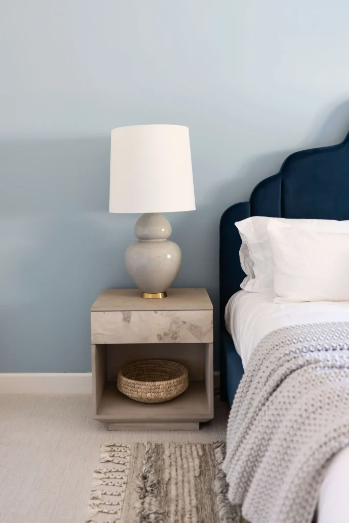 Bedroom with blue accent wall and bedside lamp décor