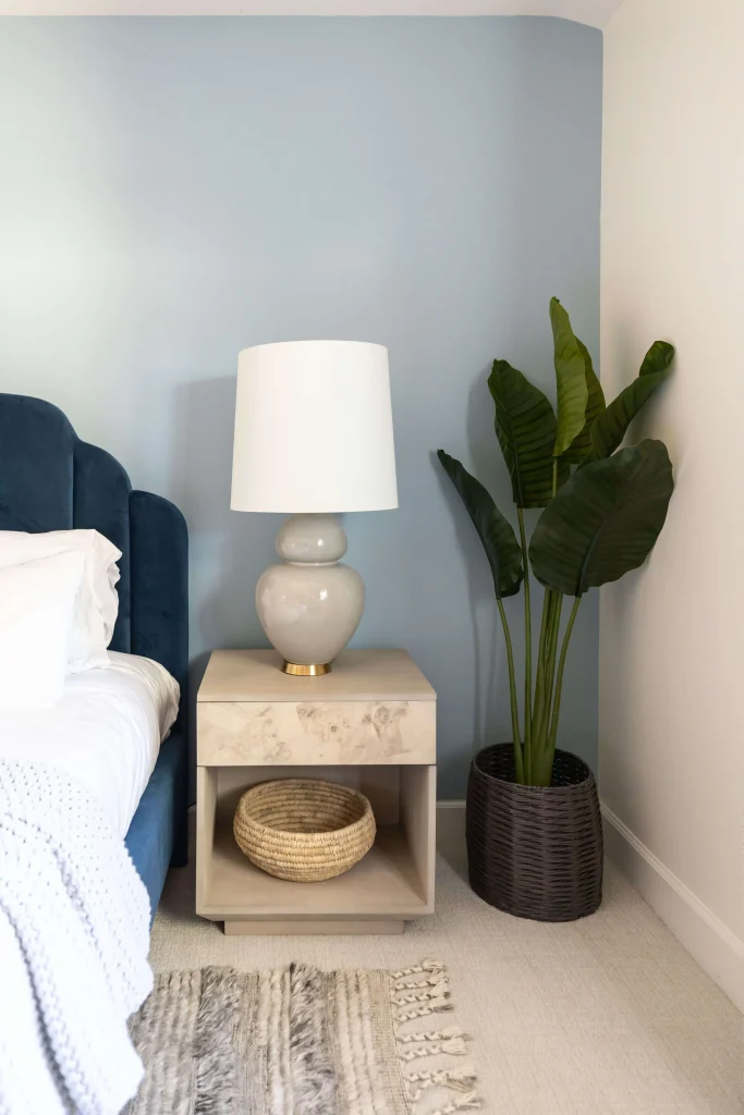 Bedroom corner with plant décor and bedside table styling