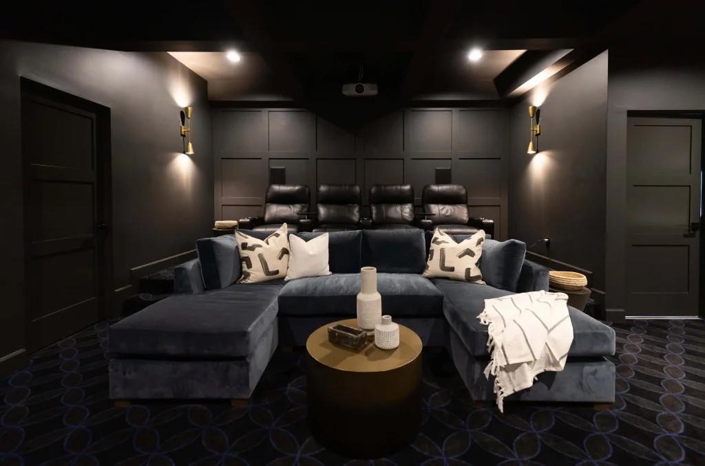 Dark home theater with plush seating and cozy decor