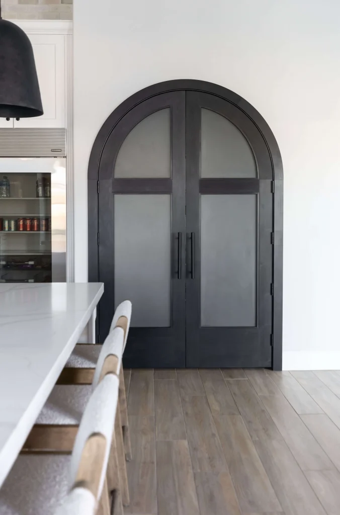 Black arched double doors in modern kitchen